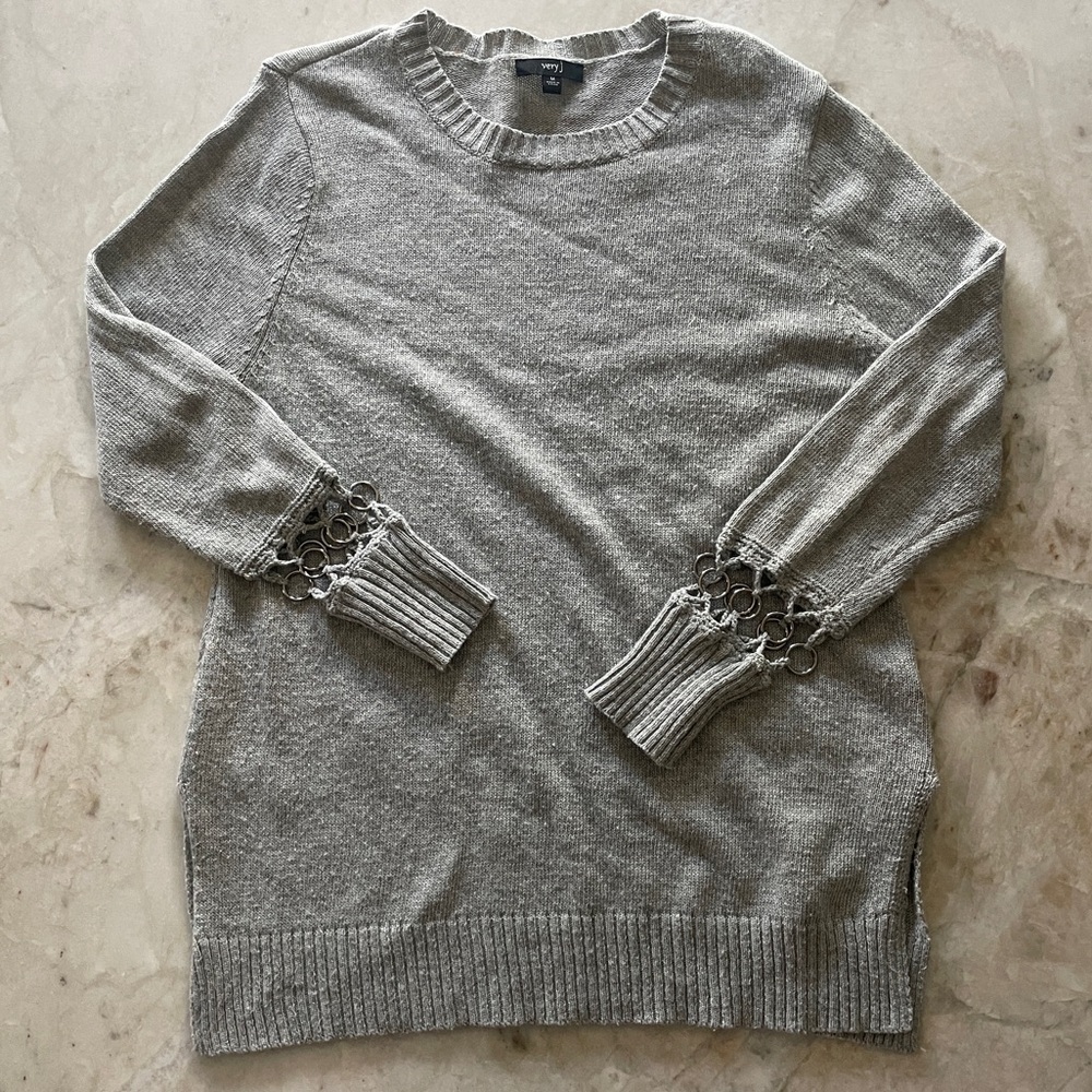 Grey sweater with crochet metal ring detailing on the sleeves
